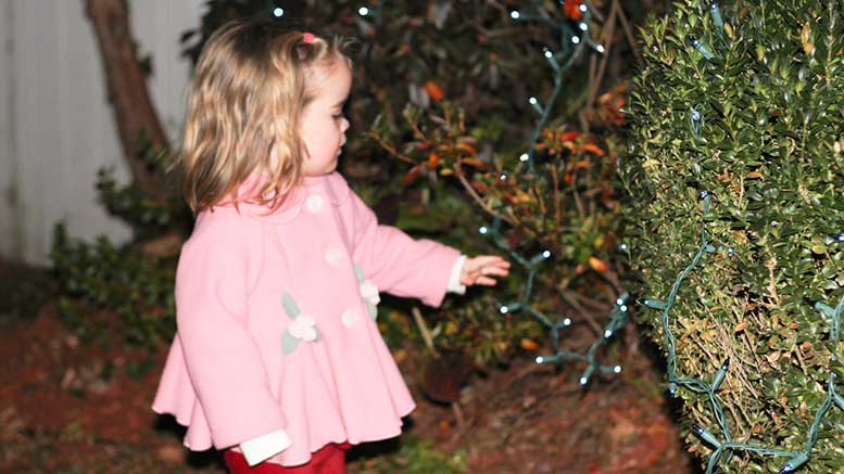 Child with Christmas lights