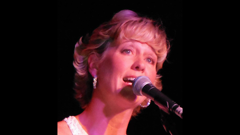 A woman singing into a microphone.