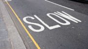 A street with the word slow painted on it.