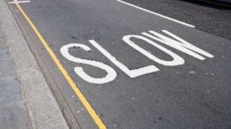 A street with the word slow painted on it.