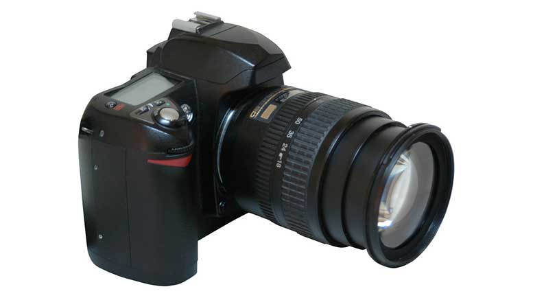 A black dslr camera on a white background.
