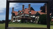 A mansion is reflected in a frame at Eustis Estate Museum.