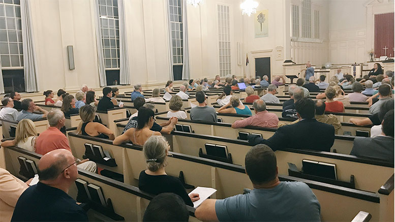 The East Church was packed with East Milton Neighborhood Association members who listened to the proposal for the five story Falconi development