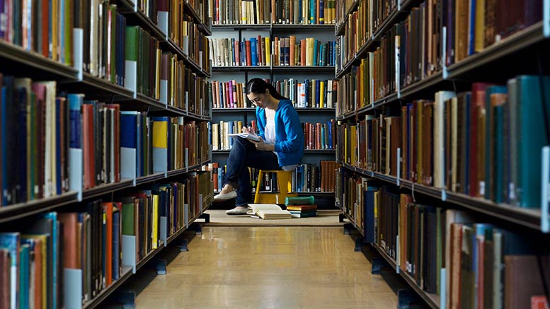 student in library