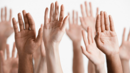 100 Women Who Care Milton raising their hands in the air at the virtual June event.