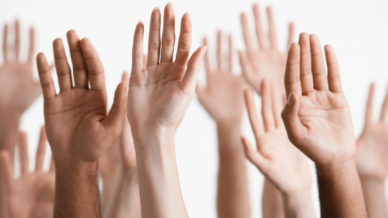 100 Women Who Care Milton raising their hands in the air at the virtual June event.