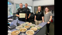 Milton Women's Club show their appreciation for Milton's essential front line workers by posing for a photo with a police officer.