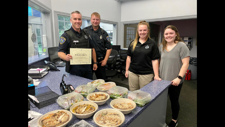 Milton Women's Club show their appreciation for Milton's essential front line workers by posing for a photo with a police officer.