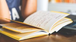 school girl reading notebook classroom