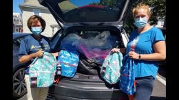 Jennifer White, left, Vice President of Community and Public Relations for HarborOne Bank, delivers backpacks to Interfaith Social Services’ Family and Children Program Manager Emily Ryan, right. HarborOne employees donated and assembled 150 backpacks for Interfaith’s 2020 Backpack Drive.