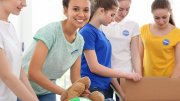Outfitted in their pink t-shirts, a group of girls lovingly cradle a teddy bear wrapped in donated DOVE packaging, ready to spread cheer through DOVE's hosting of