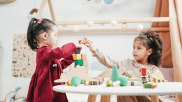 Calling all Kindergarten girls in Milton! Join us for a fun playdate where two little girls can enjoy playing with wooden blocks in a room.