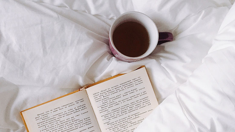 book in bed with tea