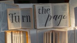 open books with large "turn the page" text