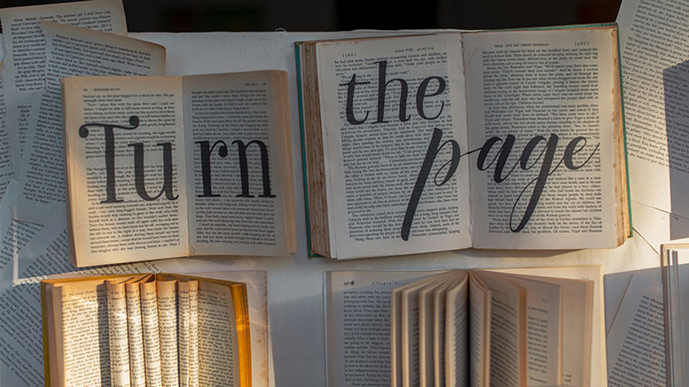 open books with large "turn the page" text