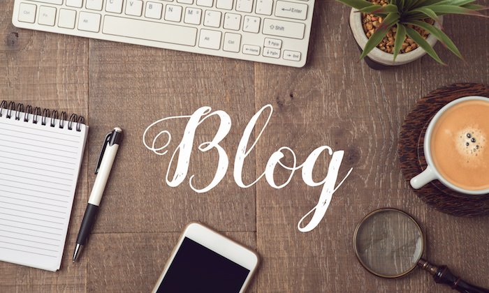 The word 'blog' around keyboard, phone, other items