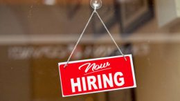 A new hiring sign hanging from a window. When you have a smaller team, every hire is important.