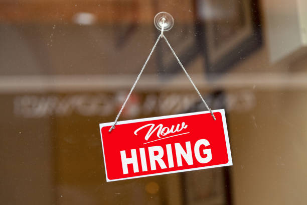 A new hiring sign hanging from a window. When you have a smaller team, every hire is important.