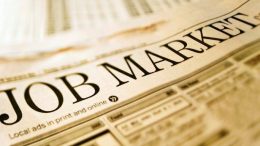 A newspaper with the word job market, emphasizing the importance of hiring the right people for small business success.