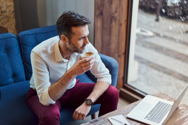 Man on computer by window