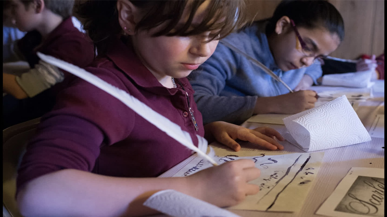 Local Voices Family Day at the Eustis Estate - kids writing with quills