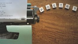 typewriter with the word POETRY spelled out in block letters