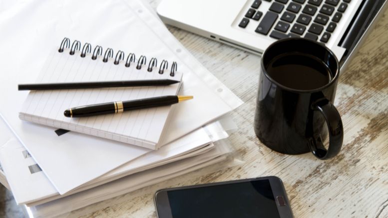 work items: desk computer mug pens