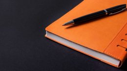 orange notebook for meeting notes and agenda. image: canva