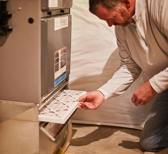 Man changing furnace filter. Source: Laura McGuire, Filtersfast.com