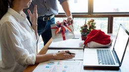 worker at desk during holidays. image: canva