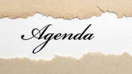 A piece of paper with the word agenda written on it. For a local meeting.