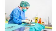 A female nurse, known for her expertise in the field of health, skillfully operates on a patient laying on a surgical table.