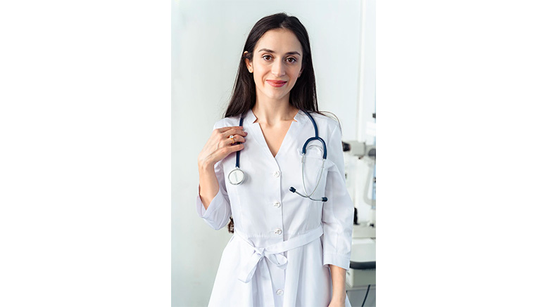 A female doctor in a white coat holding a stethoscope, experiencing the fulfillment of her nursing career.