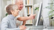An older couple using a computer at home for the Senior Tax Workoff Program in the Town of Milton to receive a $2,000 tax abatement.