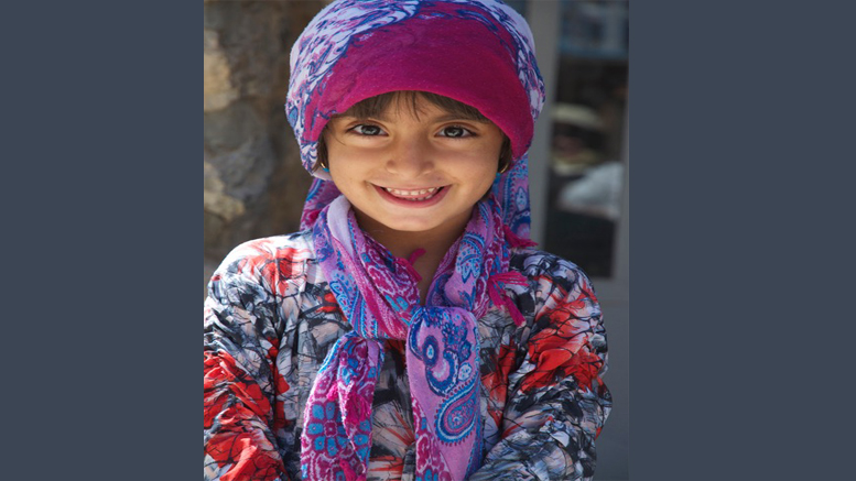 Young girl wearing a hat and scarf attends Milton Public Library's adult programming.