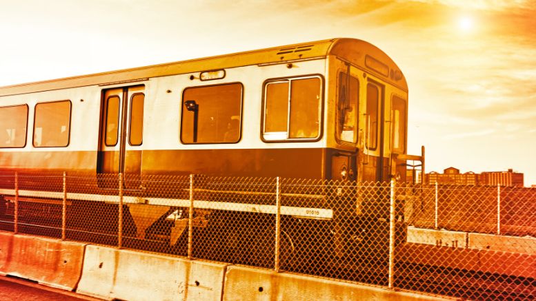 An MBTA red line train is traveling down the tracks