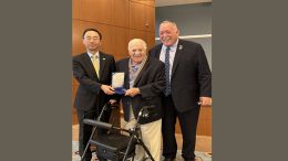 A man in a suit and a man in a wheelchair are posing for a picture during the May 29,2023 Milton Memorial Day Ceremonies.