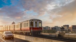 An MBTA red line train is traveling down the tracks