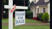 A "sold" sign overlaying a "house for sale" sign in front of a residential home as August property prices reach record highs in Norfolk County.