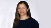 Woman with long dark hair wearing a pearl necklace and black top, smiling at the camera against a white background. Rob Levash announces candidacy for Milton Planning Board.