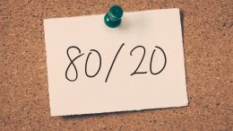 Note pinned to a corkboard with "80/20" written on it.