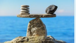 Stacked stones on a horizontal slab, artfully balanced atop a larger rock, mirror the harmony required in business. Just as the sea and sky blend seamlessly, mastering the power of local marketing can help your small business dominate your neighborhood with ease.