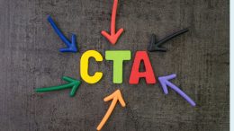 The letters "CTA" in yellow, green, and red are surrounded by colorful arrows pointing towards them on a dark surface, illustrating how lead magnets can be your secret weapon for turning clicks into customers.