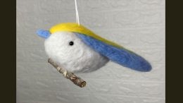 A charming wool felt bird ornament with blue and yellow wings, perfect for adding a touch of whimsy to your 2025 celebrations. This delightful piece hangs gracefully from a string, making it an ideal gift for the boozy bookworms meetup at Steel & Rye on March 27.