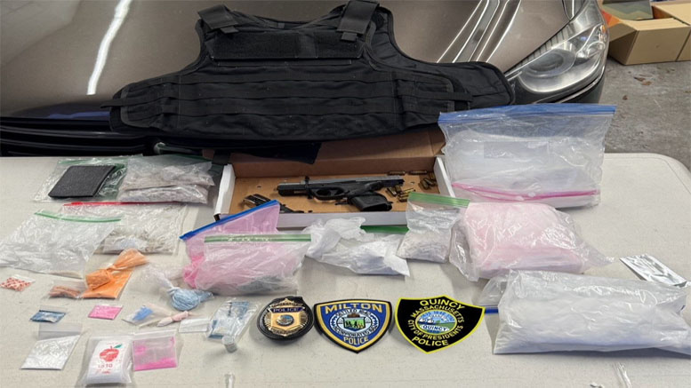 A table displays a bulletproof vest, a handgun, various bags of substances, small containers, and two police badges in front of a car's hood—a scene from the Milton Police's 2025 home invasion bust on March 18.