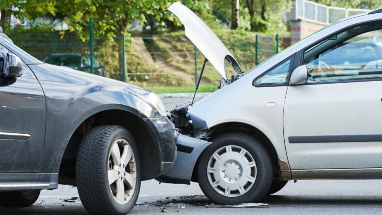 Two cars have collided on a street, the front of one crumpled against the back of the other. Both vehicles are stationary amidst outdoor greenery. As part of Small Business Corner, understanding how businesses should deal with traffic accidents caused by their vehicles is crucial for responsible management.