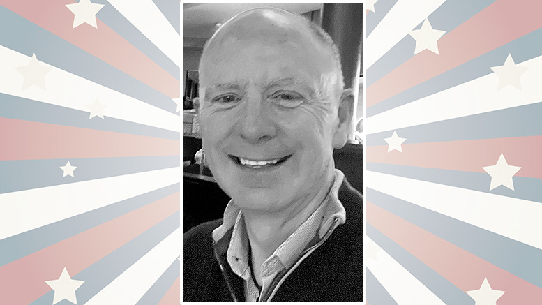 A smiling person in a black and white photo is centered on a background with stars and stripes in red, white, and blue.