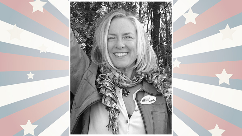Smiling person wearing a scarf and jacket with an "I Voted" sticker, set against a starburst background with stars and stripes.